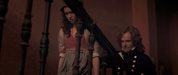 Movie still from “Byzantium” (2012), directed by Neil Jordan – A man and a woman standing next to a railing; Medium shot, High angle