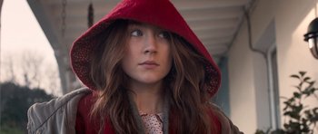 Movie still from “Byzantium” (2012), directed by Neil Jordan – A woman wearing a red hooded jacket looking to her left; Close Up shot, Over the shoulder angle