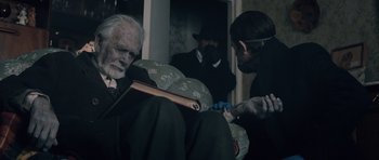 Movie still from “Byzantium” (2012), directed by Neil Jordan – An old man sitting on a chair with a cane; Medium shot, Over the shoulder angle