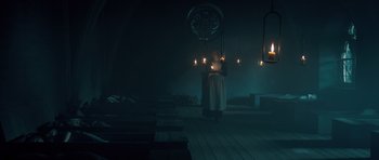Movie still from “Byzantium” (2012), directed by Neil Jordan – A woman standing in a dark room holding a candle; Wide shot, Low angle