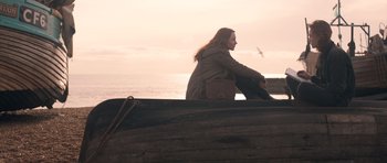 Movie still from “Byzantium” (2012), directed by Neil Jordan – A woman sitting on the side of a wooden boat; Wide shot, Low angle