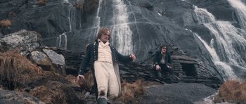 Movie still from “Byzantium” (2012), directed by Neil Jordan – A man and a woman sitting in front of a waterfall; Wide shot, Low angle