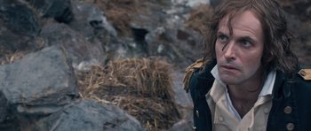 Movie still from “Byzantium” (2012), directed by Neil Jordan – A man in a military uniform standing in front of rocks; Close Up shot, High angle