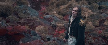 Movie still from “Byzantium” (2012), directed by Neil Jordan – A man standing in front of a body of blood; Medium shot, High angle