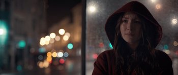 Movie still from “Byzantium” (2012), directed by Neil Jordan – A young woman wearing a red hooded jacket looking out of a window; Close Up shot, Over the shoulder angle