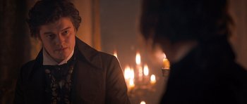 Movie still from “Byzantium” (2012), directed by Neil Jordan – A man sitting in front of a fireplace holding a candle; Close Up shot, Over the shoulder angle