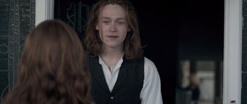 Movie still from “Byzantium” (2012), directed by Neil Jordan – A man with long red hair wearing a white shirt; Close Up shot, Over the shoulder angle