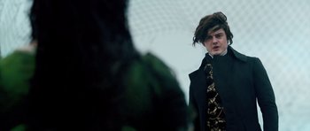 Movie still from “Byzantium” (2012), directed by Neil Jordan – A man with a black jacket and a black and gold tie; Medium shot, Low angle