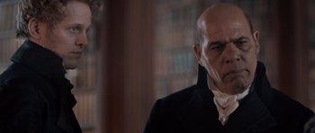 Movie still from “Byzantium” (2012), directed by Neil Jordan – A man with a bald head wearing a black jacket; Close Up shot, Over the shoulder angle