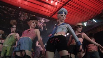 Movie still from “Cabaret” (1972), directed by Bob Fosse – A group of women dressed in costumes and lingerie; Medium shot, Low angle