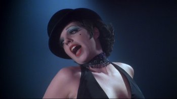 Movie still from “Cabaret” (1972), directed by Bob Fosse – A person wearing a hat; Close Up shot, Low angle