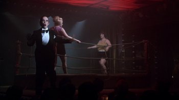 Movie still from “Cabaret” (1972), directed by Bob Fosse – A couple of people are in a boxing ring; Wide shot, Low angle