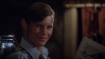 Movie still from “Cabaret” (1972), directed by Bob Fosse – A young man wearing a striped shirt and a tie; Close Up shot, Over the shoulder angle