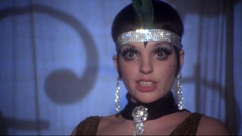 Movie still from “Cabaret” (1972), directed by Bob Fosse – A person wearing a headpiece; Close Up shot, Low angle