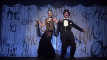 Movie still from “Cabaret” (1972), directed by Bob Fosse – A man and a woman performing on a stage; Wide shot, Low angle