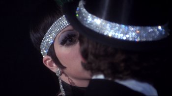Movie still from “Cabaret” (1972), directed by Bob Fosse – A person wearing a hat; Close Up shot, Over the shoulder angle
