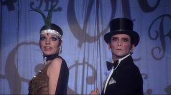 Movie still from “Cabaret” (1972), directed by Bob Fosse – A man and a woman dressed up in costume; Close Up shot, Low angle