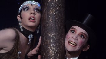 Movie still from “Cabaret” (1972), directed by Bob Fosse – A man and a woman dressed as a flapper and a vampire; Close Up shot, Low angle