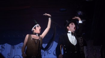 Movie still from “Cabaret” (1972), directed by Bob Fosse – A man and a woman performing on a stage; Medium shot, Low angle