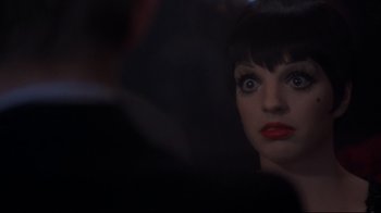 Movie still from “Cabaret” (1972), directed by Bob Fosse – A person looking at the camera; Close Up shot, Over the shoulder angle