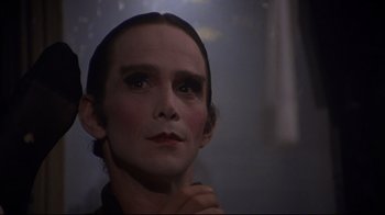 Movie still from “Cabaret” (1972), directed by Bob Fosse – A person wearing makeup and looking up; Close Up shot, Low angle