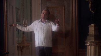 A man standing in a room with his arms outstreched