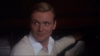 Movie still from “Cabaret” (1972), directed by Bob Fosse – A person wearing a white shirt; Close Up shot, Over the shoulder angle