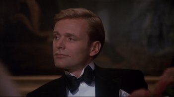 Movie still from “Cabaret” (1972), directed by Bob Fosse – A person wearing a suit and a bow tie; Close Up shot, Low angle