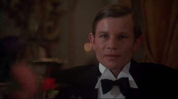 Movie still from “Cabaret” (1972), directed by Bob Fosse – A man in a suit and bow tie; Close Up shot, Over the shoulder angle