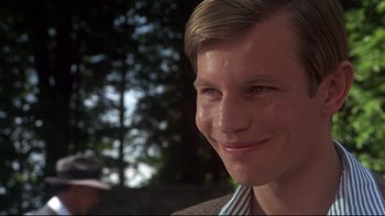 Movie still from “Cabaret” (1972), directed by Bob Fosse – A man smiling for the camera; Close Up shot, Low angle