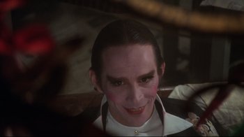 Movie still from “Cabaret” (1972), directed by Bob Fosse – A person wearing a mask; Close Up shot, Over the shoulder angle