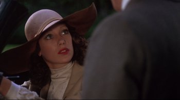 Movie still from “Cabaret” (1972), directed by Bob Fosse – A person wearing a hat; Close Up shot, Over the shoulder angle