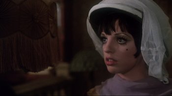 Movie still from “Cabaret” (1972), directed by Bob Fosse – A person wearing a hat; Close Up shot, Over the shoulder angle