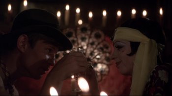 Movie still from “Cabaret” (1972), directed by Bob Fosse – A man and a woman are toasting with champagne; Close Up shot, Over the shoulder angle