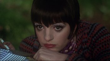 Movie still from “Cabaret” (1972), directed by Bob Fosse – A person with short black hair; Close Up shot, High angle