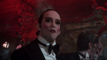Movie still from “Cabaret” (1972), directed by Bob Fosse – A man in a suit and bow tie; Close Up shot, Low angle