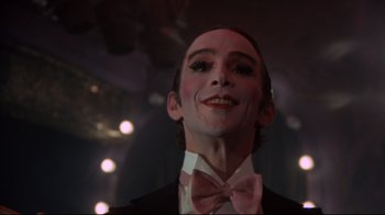 Movie still from “Cabaret” (1972), directed by Bob Fosse – A person wearing a suit and bow tie; Close Up shot, Low angle