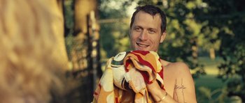 Movie still from “Café de Flore” (2011), directed by Jean-Marc Vallée – A man is holding a towel in his hands; Close Up shot, Over the shoulder angle