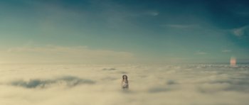 Movie still from “Café de Flore” (2011), directed by Jean-Marc Vallée – A woman standing in the middle of a cloud filled sky; Extreme Wide shot, Low angle
