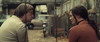 Movie still from “Café de Flore” (2011), directed by Jean-Marc Vallée – Two people standing next to each other on a street; Medium shot, Over the shoulder angle