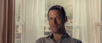 Movie still from “Café de Flore” (2011), directed by Jean-Marc Vallée – A person wearing a gray shirt near a window; Close Up shot, Low angle