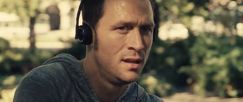 Movie still from “Café de Flore” (2011), directed by Jean-Marc Vallée – A person wearing headphones; Close Up shot, Over the shoulder angle