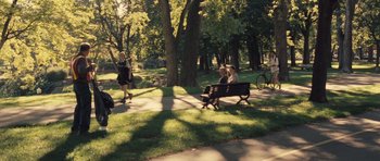 Movie still from “Café de Flore” (2011), directed by Jean-Marc Vallée – A group of people sitting on top of a park bench; Extreme Wide shot, High angle