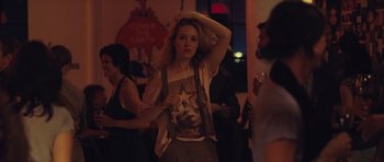 Movie still from “Café de Flore” (2011), directed by Jean-Marc Vallée – A woman standing next to a crowd of people at a party; Medium shot, Over the shoulder angle