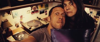 Movie still from “Café de Flore” (2011), directed by Jean-Marc Vallée – A man and a woman taking a picture of themselves; Close Up shot, Overhead angle