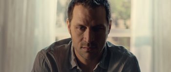 Movie still from “Café de Flore” (2011), directed by Jean-Marc Vallée – A man's face in front of a window; Close Up shot, Low angle