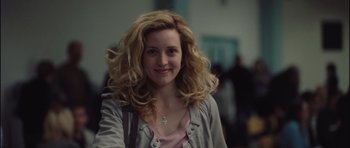 Movie still from “Café de Flore” (2011), directed by Jean-Marc Vallée – A woman with blonde curly hair smiling for the camera; Close Up shot, Over the shoulder angle
