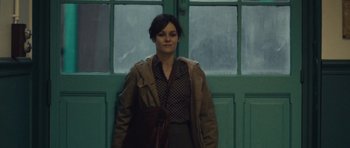 Movie still from “Café de Flore” (2011), directed by Jean-Marc Vallée – A woman standing in front of a green door; Medium shot, Low angle