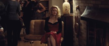 Movie still from “Café de Flore” (2011), directed by Jean-Marc Vallée – A woman in a red dress sitting on a chair in a room; Medium shot, Over the shoulder angle