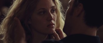Movie still from “Café de Flore” (2011), directed by Jean-Marc Vallée – A person with their hand on her chin; Close Up shot, Over the shoulder angle